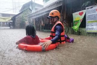 A young girl gets a ride during Typhoon Odette. (South China Morning Post)
