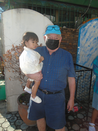 Outside the church with Amari. Face masks still a must in public in Nueva Ecija.